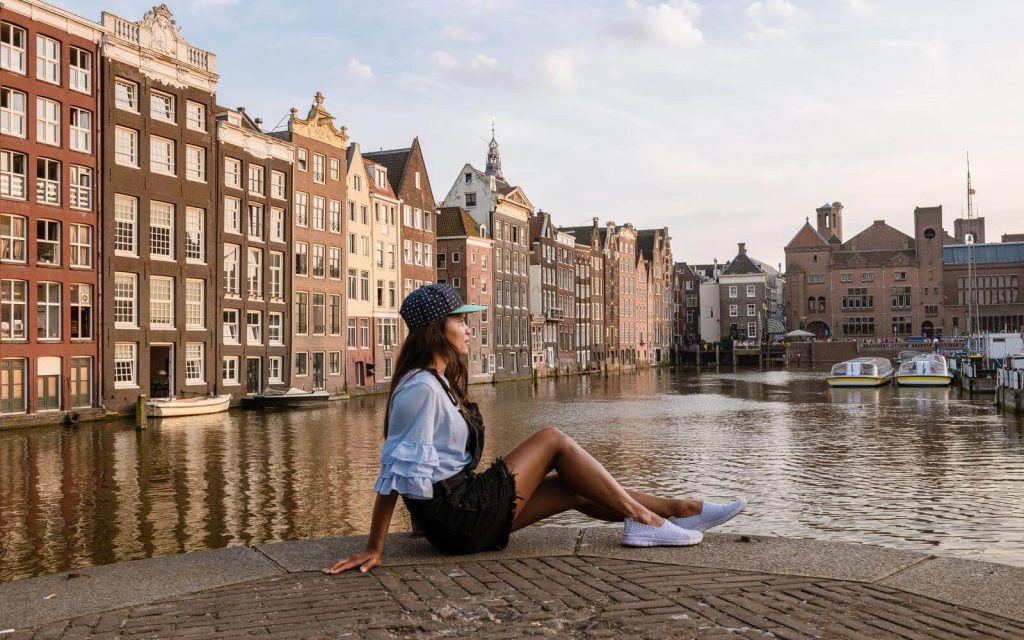 Woman by canal - What to wear in Amsterdam in July