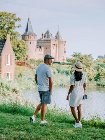 Couple in front of Muiderslot showing what to wear to Amsterdam in July