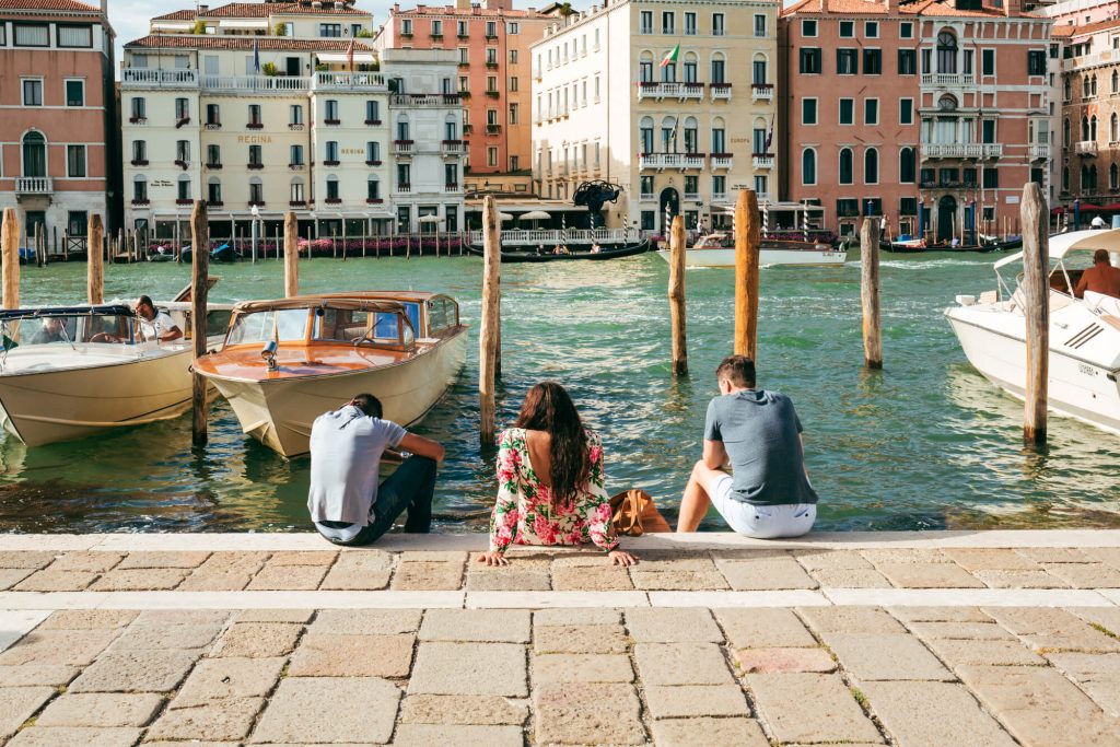 People sat near Venice Canal - What to wear to ITaly in July / What to wear to Venice in Summer