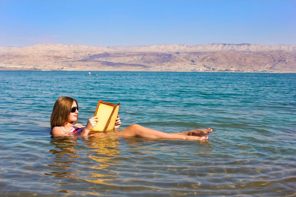 Woman reading in Dead Sea - What to wear in Dead SEa 