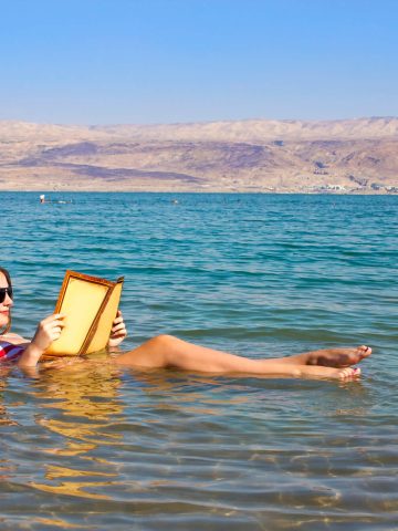 Woman reading in Dead Sea - What to wear in the Dead Sea