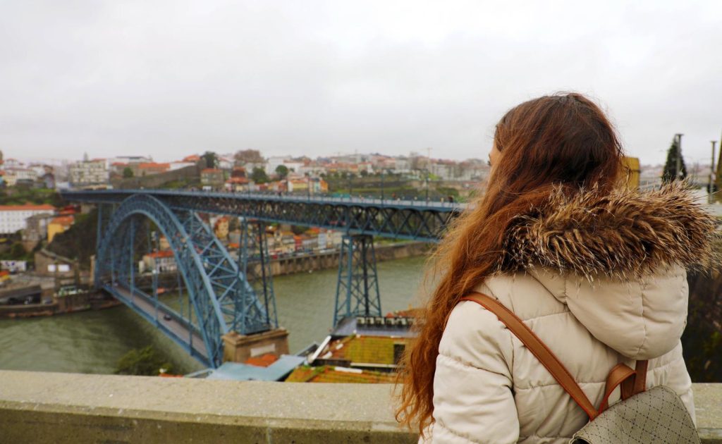 Woman overlooking Bridge in Porto