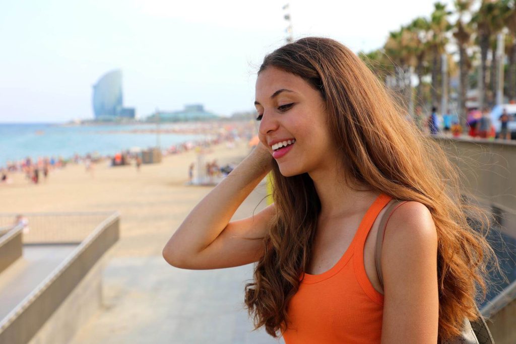 Woman with Barcelona beach in background