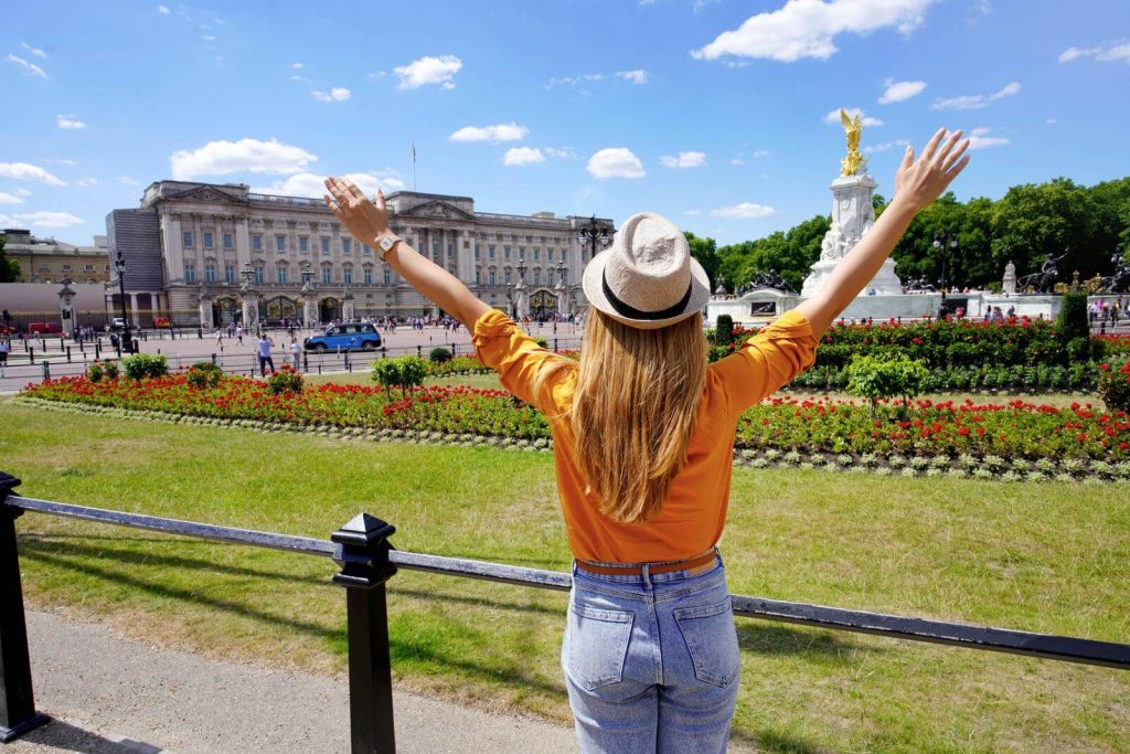 Back of Woman tourist in front of Buckingham Palace in June 