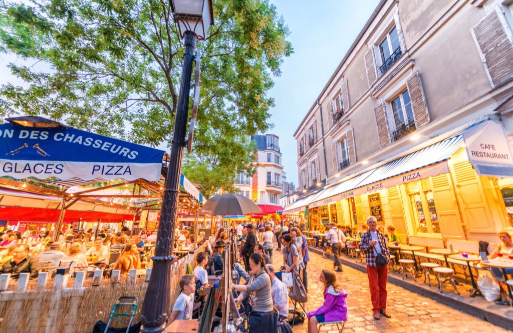 People in Montmartre in the evening on Summer night in Paris