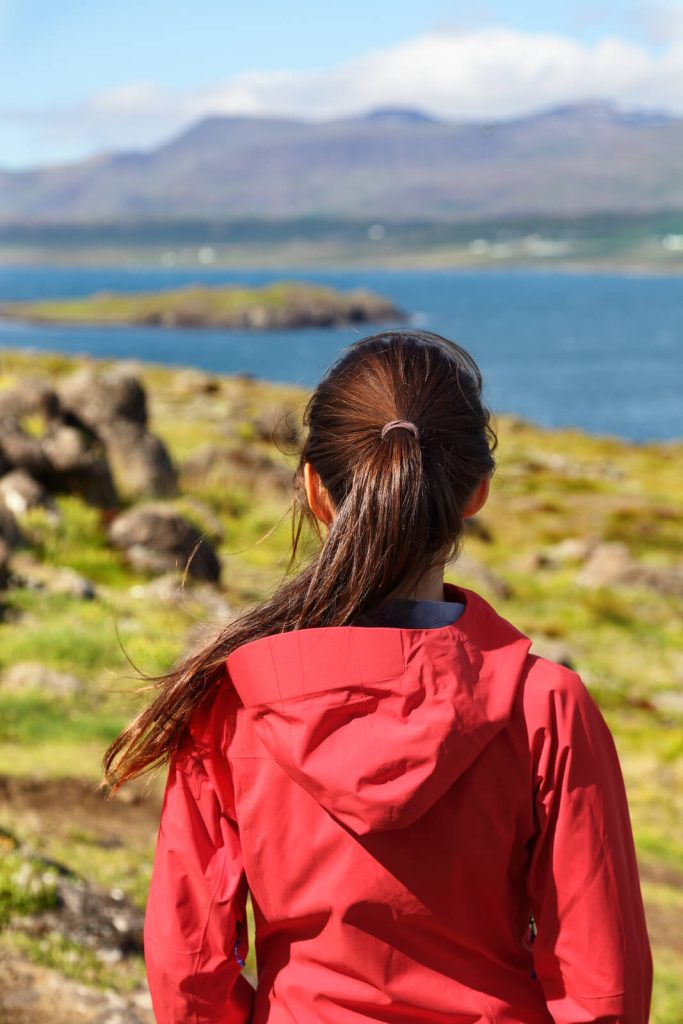 Woman with back turned to camera in Iceland in July
