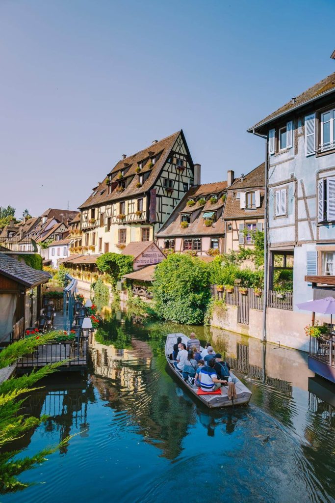 Colmar in Alsace France with boat on canal in July