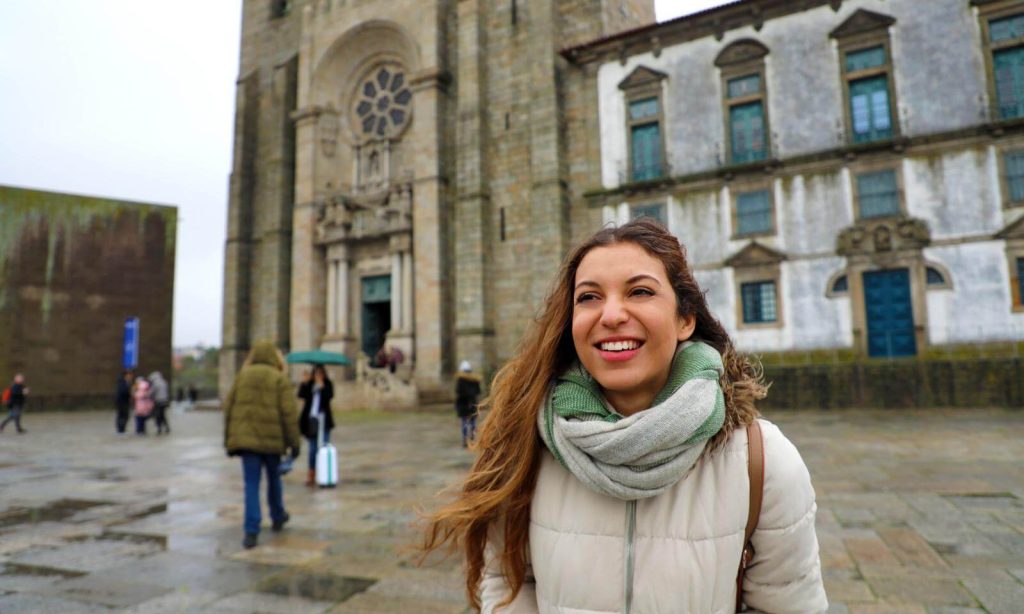 Woman in front of Porto Cathedral in Portugal In November on a rainy day