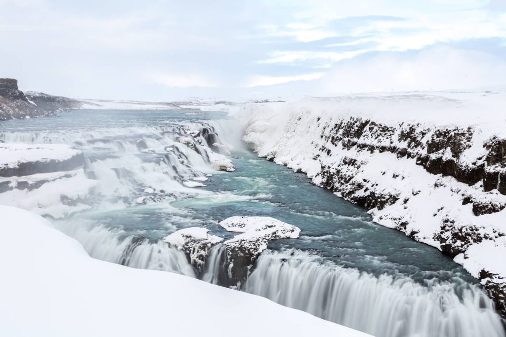 Gulfoss Waterfall in Iceland in winter covered in snow and Ice