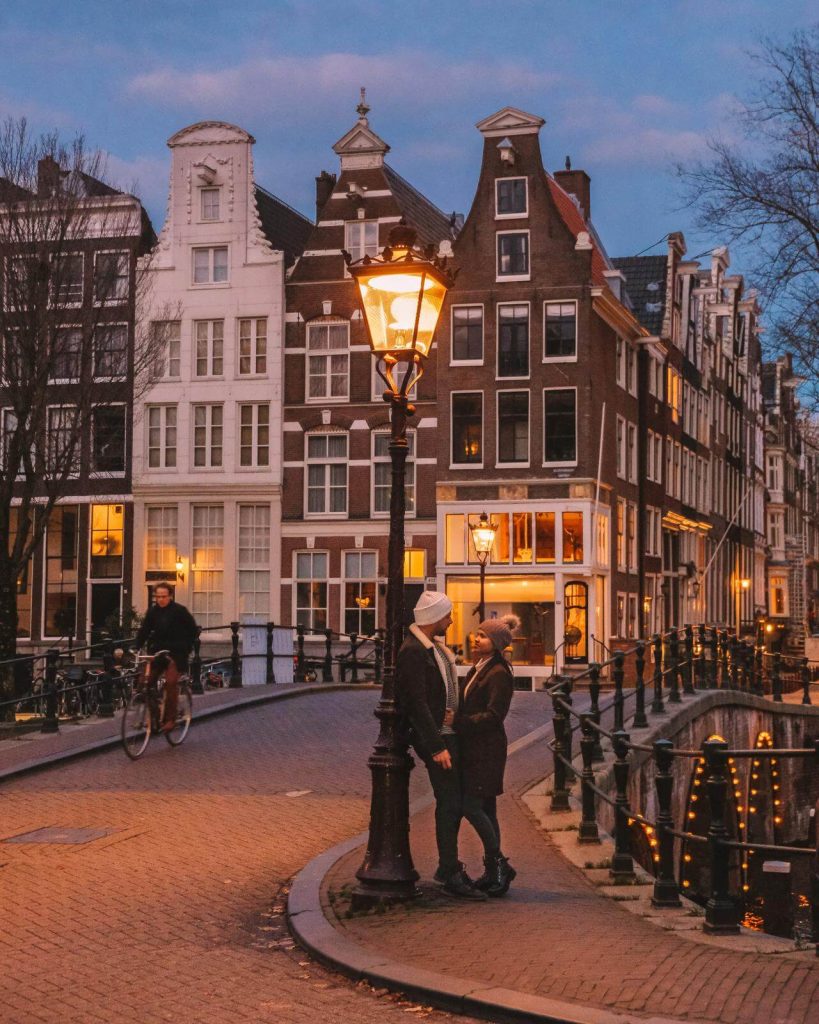 Couple stood next to lamppost in Amsterdam in January