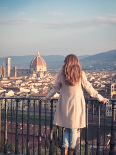 Woman standing in winter clothes overlooking FLorence Duomo