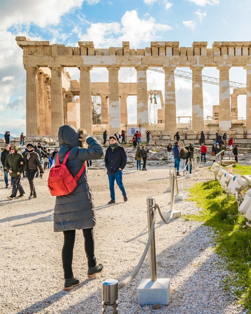 Woman at ACropolis in Athens Greece in December wearing winter coat