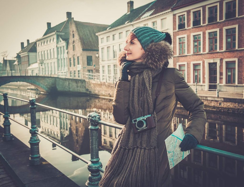 Woman in Bruges, Belgium in Winter wearing winter coat and accesories