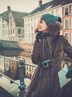 Woman in Bruges, Belgium in Winter wearing winter coat and accesories