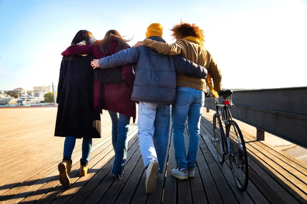 Group of friends on boardwalk in Barcelona in winter