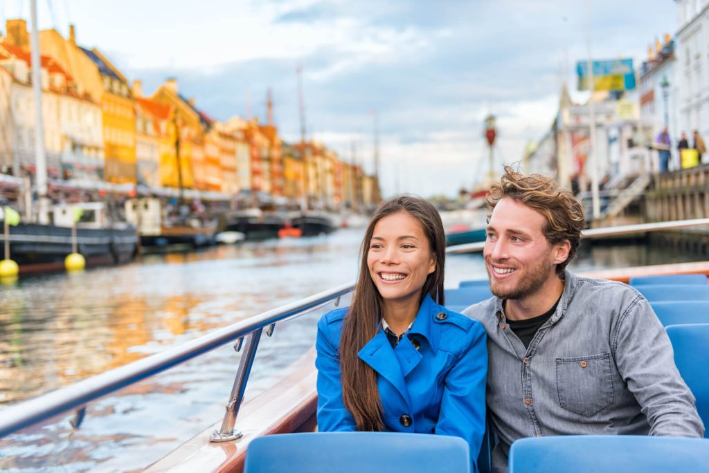 Couple on canal boat tour in Nyhavn in Copenhagen