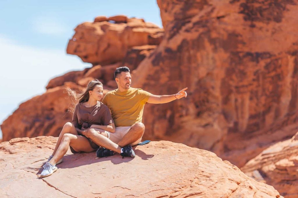 Man and woman sat on a rock in Zion National Park