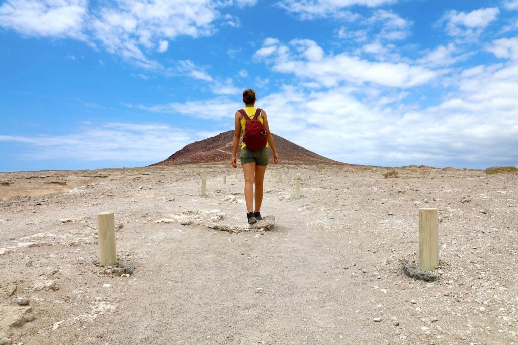 Woman walking near volcano in Tenerife