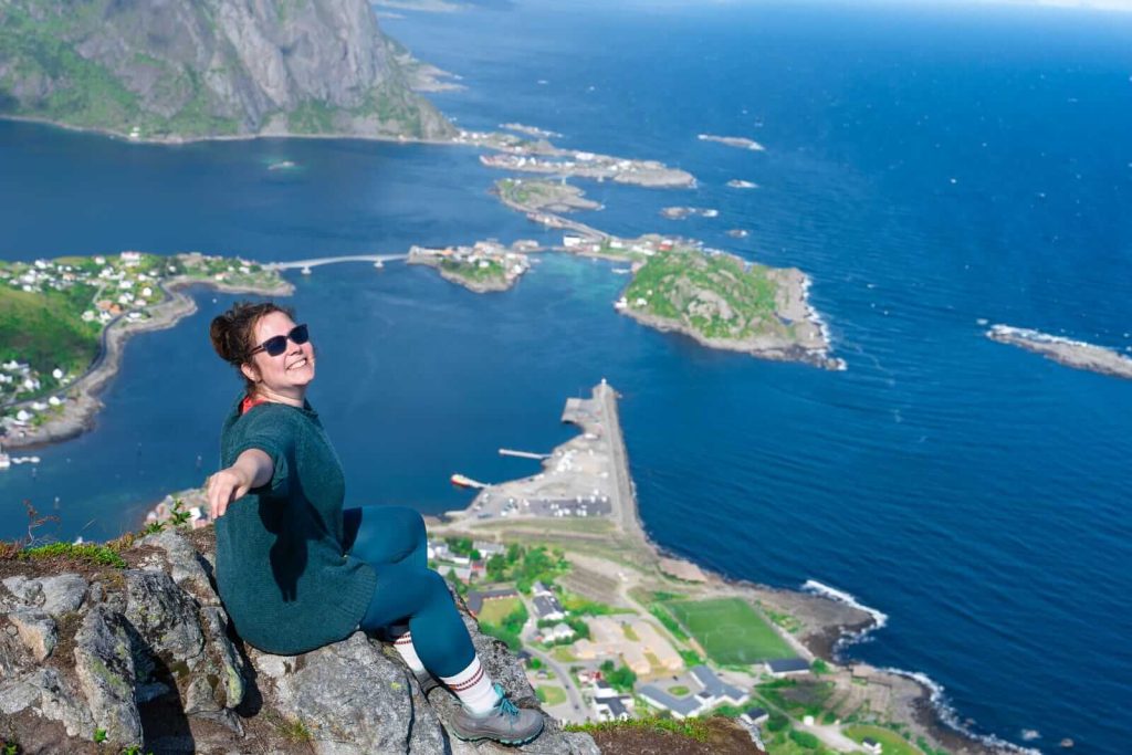 Woman on cliff edge in Lofoten Islands in Norway in Summer