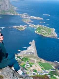 Woman on cliff edge in Lofoten Islands in Norway in Summer