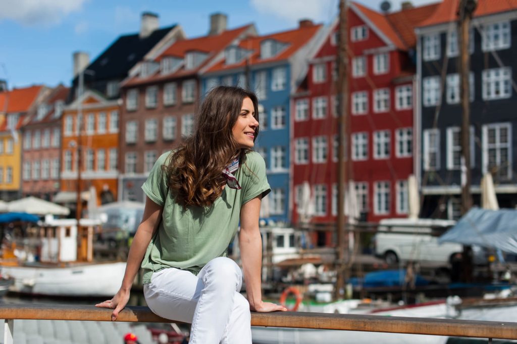 Woman sat in Nyhavn in Copenhagen in Summer