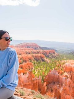 Woman in blue sweater looking at view of the Bryce Canyon National Park