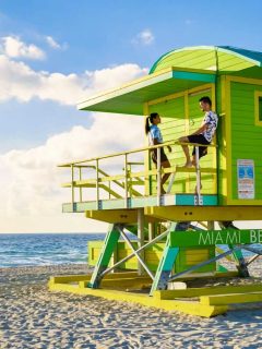 Couple in a green beach hut on Miami beach