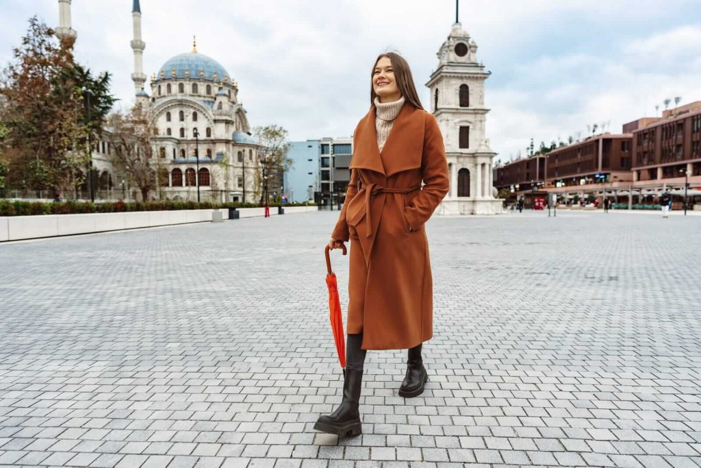 Woman in orange coat on street in Istanbul