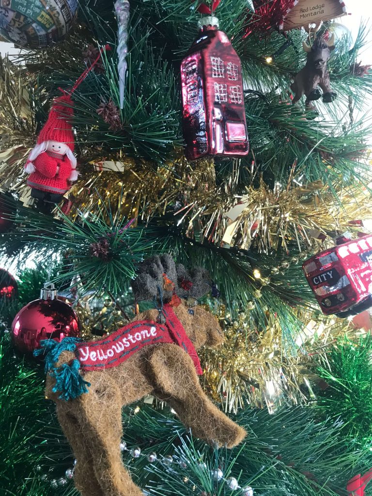 Close up of a christmas tree with ornaments from yellowstone, amsterdam and london