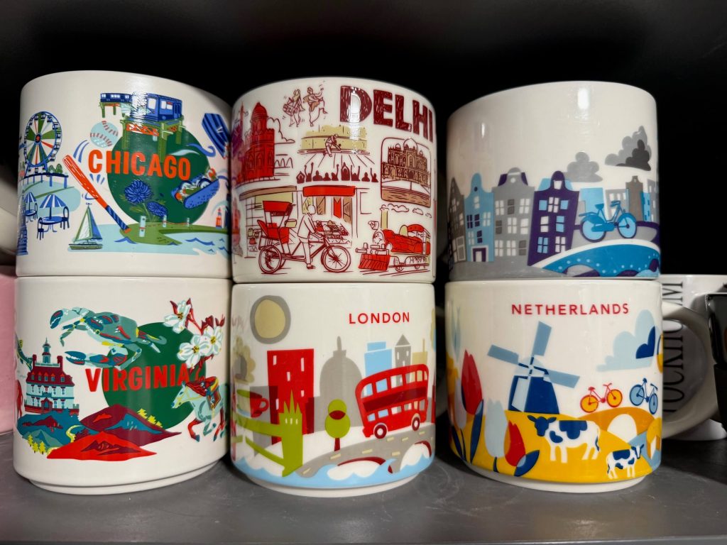 Siz Starbucks Travel mugs in a cupboard